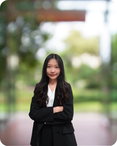 Female consultant standing outdoors with arms crossed, smiling