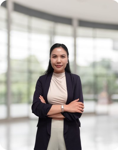 Female executive with long hair, arms folded, wearing a black blazer